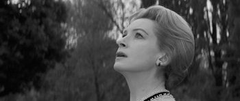 Movie still from “The Innocents” (1961), directed by Jack Clayton – Black and white photograph of a woman looking up at the sky; Close Up shot, Low angle