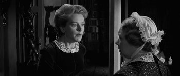 Movie still from “The Innocents” (1961), directed by Jack Clayton – An older woman talking to a younger woman in a room; Close Up shot, Over the shoulder angle