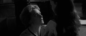 Movie still from “The Innocents” (1961), directed by Jack Clayton – A black - and - white photo of a woman and a man; Close Up shot, Over the shoulder angle