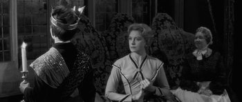 Movie still from “The Innocents” (1961), directed by Jack Clayton – A black and white photo of a woman and a man; Medium shot, Over the shoulder angle