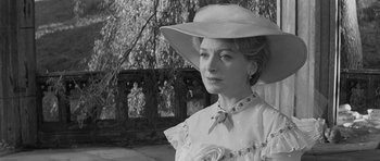 Movie still from “The Innocents” (1961), directed by Jack Clayton – A black and white photo of a woman wearing a hat; Close Up shot, Over the shoulder angle
