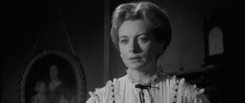 Movie still from “The Innocents” (1961), directed by Jack Clayton – An old photo of a woman in a white dress; Close Up shot, Low angle