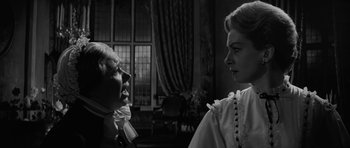 Movie still from “The Innocents” (1961), directed by Jack Clayton – A man and a woman are talking in a living room; Close Up shot, Over the shoulder angle