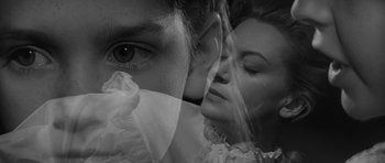 Movie still from “The Innocents” (1961), directed by Jack Clayton – A person's face with a veil over their face; Close Up shot, Low angle