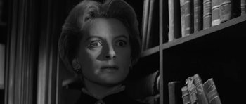 Movie still from “The Innocents” (1961), directed by Jack Clayton – An older woman looking up at the camera; Close Up shot, Low angle