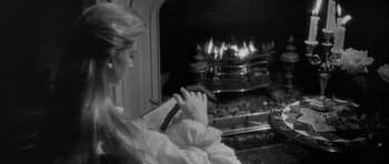 Movie still from “The Innocents” (1961), directed by Jack Clayton – A woman sitting in front of a fire place; Close Up shot, Over the shoulder angle