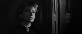 Movie still from “The Innocents” (1961), directed by Jack Clayton – An old photo of a woman in a dark room; Close Up shot, Low angle