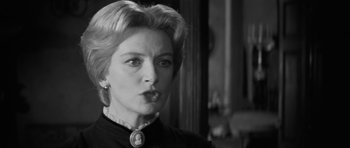 Movie still from “The Innocents” (1961), directed by Jack Clayton – An old photo of a woman in a black dress; Close Up shot, Over the shoulder angle