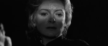 Movie still from “The Innocents” (1961), directed by Jack Clayton – Black and white photograph of a woman's face in the dark; Close Up shot, Low angle