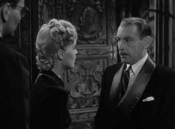 Movie still from “The Invisible Man Returns” (1940), directed by Joe May – An older man and a young woman in a room; Close Up shot, Over the shoulder angle