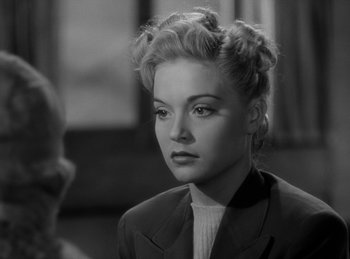 Movie still from “The Invisible Man Returns” (1940), directed by Joe May – A black - and - white photo of a woman in a suit; Close Up shot, Over the shoulder angle