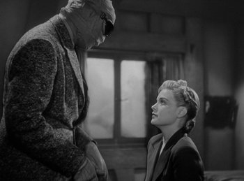 Movie still from “The Invisible Man Returns” (1940), directed by Joe May – A man and a woman are looking at one another; Medium shot, Low angle