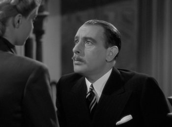 Movie still from “The Invisible Man Returns” (1940), directed by Joe May – A man wearing a suit and tie talking to another man wearing a tie; Close Up shot, Over the shoulder angle