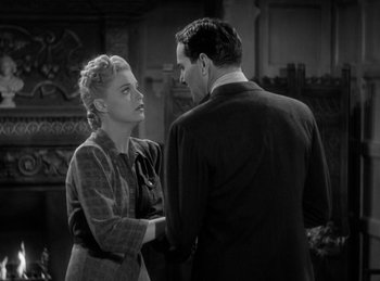 Movie still from “The Invisible Man Returns” (1940), directed by Joe May – A man and a woman standing next to each other; Medium shot, High angle