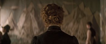 Movie still from “The Invisible Woman” (2013), directed by Ralph Fiennes – The back of a woman's head wearing a black dress; Close Up shot, Over the shoulder angle
