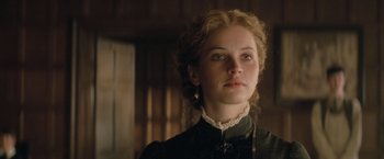Movie still from “The Invisible Woman” (2013), directed by Ralph Fiennes – A woman in a black dress looking to her left; Close Up shot, Low angle