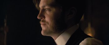 Movie still from “The Invisible Woman” (2013), directed by Ralph Fiennes – A person wearing a suit and tie; Close Up shot, Low angle