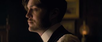Movie still from “The Invisible Woman” (2013), directed by Ralph Fiennes – A person wearing a suit and tie; Close Up shot, Over the shoulder angle