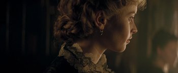 Movie still from “The Invisible Woman” (2013), directed by Ralph Fiennes – A person's hair in a bun; Close Up shot, Over the shoulder angle