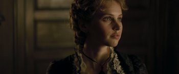 Movie still from “The Invisible Woman” (2013), directed by Ralph Fiennes – A person wearing a dress; Close Up shot, Over the shoulder angle