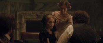 Movie still from “The Invisible Woman” (2013), directed by Ralph Fiennes – Two women sitting next to each other on a bench; Medium shot, Over the shoulder angle