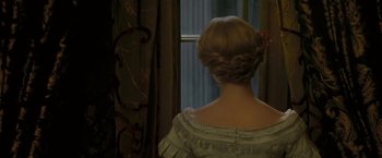Movie still from “The Invisible Woman” (2013), directed by Ralph Fiennes – A woman in a white dress looking out a window; Close Up shot, Over the shoulder angle