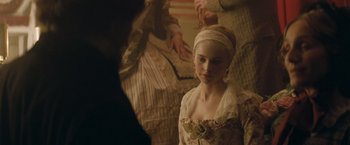 Movie still from “The Invisible Woman” (2013), directed by Ralph Fiennes – A young woman in a period dress looking at a man in an old - fashioned suit; Close Up shot, Over the shoulder angle