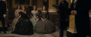 Movie still from “The Invisible Woman” (2013), directed by Ralph Fiennes – A group of women sitting on a floor; Wide shot, High angle