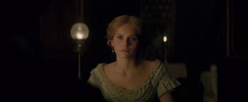 Movie still from “The Invisible Woman” (2013), directed by Ralph Fiennes – A woman in a white dress is looking at the camera; Close Up shot, Over the shoulder angle