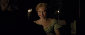Movie still from “The Invisible Woman” (2013), directed by Ralph Fiennes – A woman in a green dress smiling for the camera; Close Up shot, Over the shoulder angle