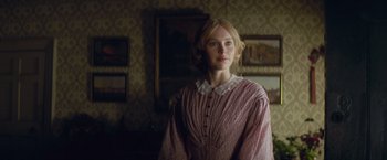 Movie still from “The Invisible Woman” (2013), directed by Ralph Fiennes – A woman standing in a room with a painting on the wall; Medium shot, Over the shoulder angle
