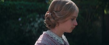 Movie still from “The Invisible Woman” (2013), directed by Ralph Fiennes – A young woman with blonde hair wearing a dress; Close Up shot, Over the shoulder angle