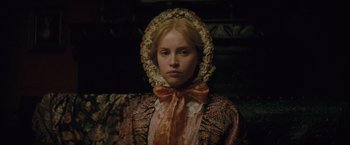 Movie still from “The Invisible Woman” (2013), directed by Ralph Fiennes – A woman in a dress and a hat; Close Up shot, Over the shoulder angle