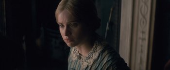 Movie still from “The Invisible Woman” (2013), directed by Ralph Fiennes – A woman in a blue and white striped dress looking to her left; Close Up shot, Over the shoulder angle