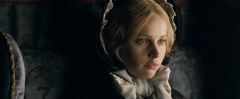 Movie still from “The Invisible Woman” (2013), directed by Ralph Fiennes – A person wearing a dress; Close Up shot, Over the shoulder angle