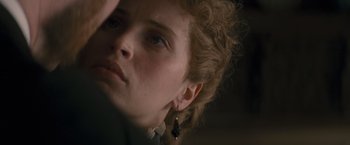 Movie still from “The Invisible Woman” (2013), directed by Ralph Fiennes – A person wearing earrings; Close Up shot, Over the shoulder angle