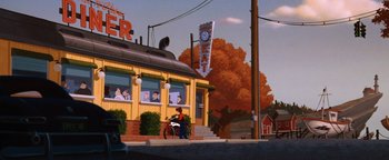 Movie still from “The Iron Giant” (1999), directed by Brad Bird – A man sitting on a bench outside of a building; Extreme Wide shot, Low angle
