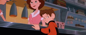 Movie still from “The Iron Giant” (1999), directed by Brad Bird – A boy and a woman are looking at something; Close Up shot, Over the shoulder angle