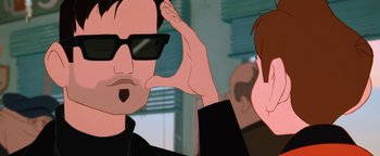 Movie still from “The Iron Giant” (1999), directed by Brad Bird – A cartoon of a man with sunglasses on and another man with his hand up to his ear; Close Up shot, Over the shoulder angle