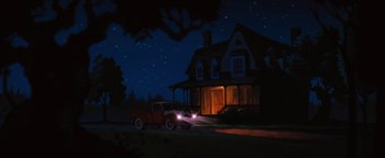 Movie still from “The Iron Giant” (1999), directed by Brad Bird – An illustration of an old red truck in front of a house at night; Extreme Wide shot, Low angle