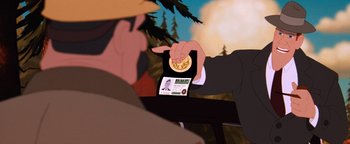 Movie still from “The Iron Giant” (1999), directed by Brad Bird – A person is holding up an electronic device; Close Up shot, Over the shoulder angle