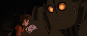 Movie still from “The Iron Giant” (1999), directed by Brad Bird – A young boy is looking at a giant robot; Medium shot, Low angle