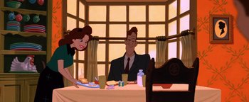 Movie still from “The Iron Giant” (1999), directed by Brad Bird – An animated scene of a man and woman sitting at a dinner table; Medium shot, Over the shoulder angle