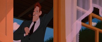 Movie still from “The Iron Giant” (1999), directed by Brad Bird – A man in a suit and tie is smiling; Close Up shot, Low angle