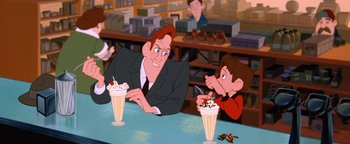 Movie still from “The Iron Giant” (1999), directed by Brad Bird – A man sitting at a table in front of a boy; Medium shot, Over the shoulder angle
