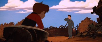 Movie still from “The Iron Giant” (1999), directed by Brad Bird – A scene of a boy and a man standing in a field; Medium shot, Low angle