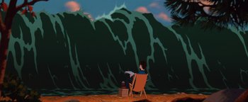 Movie still from “The Iron Giant” (1999), directed by Brad Bird – A man sitting in a lawn chair in front of an ocean wave; Extreme Wide shot, High angle