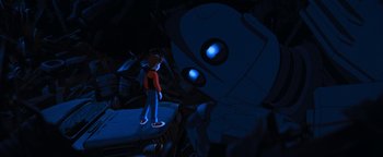 Movie still from “The Iron Giant” (1999), directed by Brad Bird – A boy standing in front of a giant robot; Wide shot, Low angle