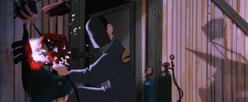 Movie still from “The Iron Giant” (1999), directed by Brad Bird – A man with a helmet is sitting in front of a door; Medium shot, Low angle