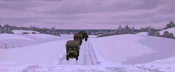 Movie still from “The Iron Giant” (1999), directed by Brad Bird – A group of trucks driving down a snow covered road; Extreme Wide shot, Low angle